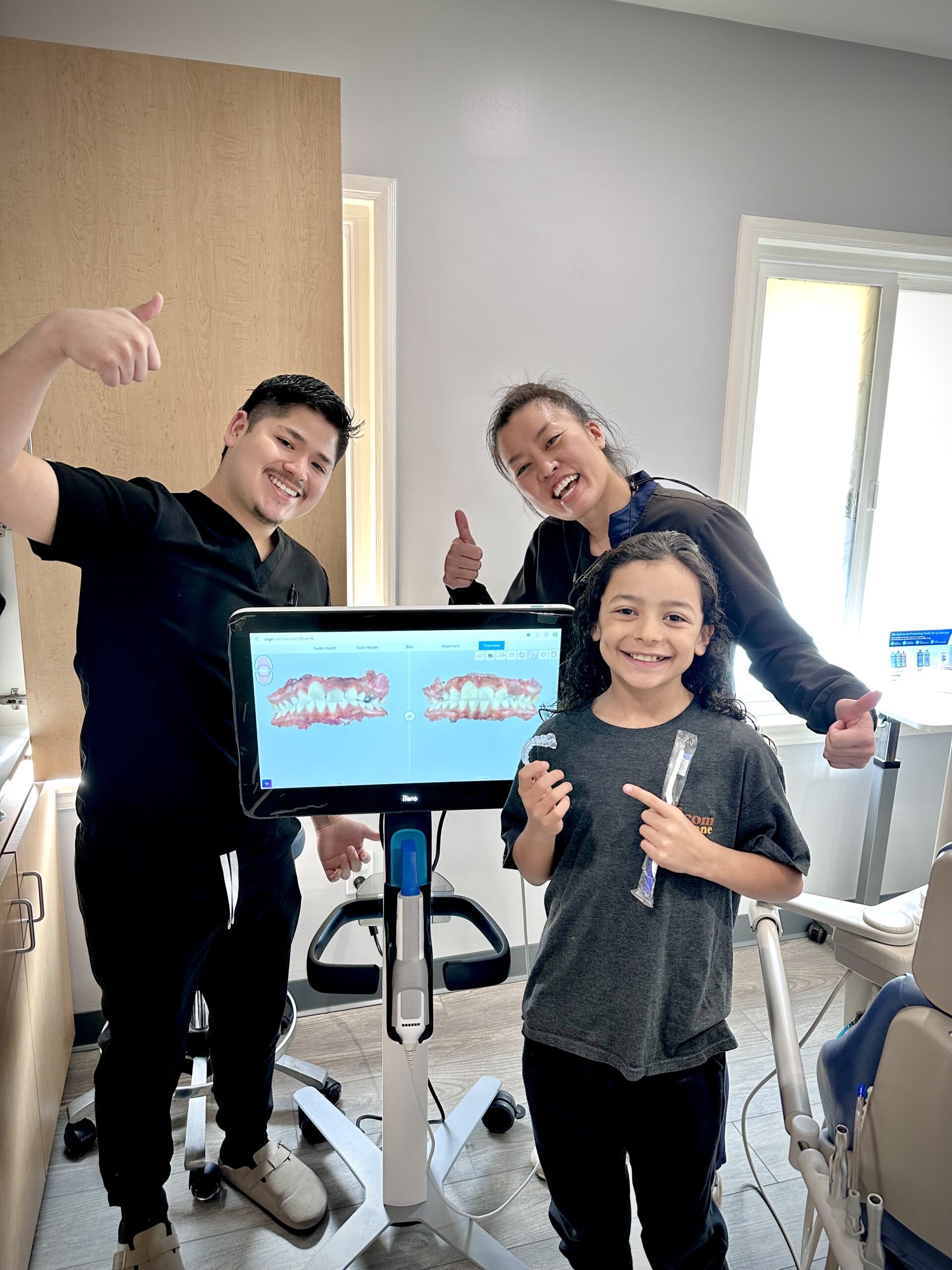 An iTero 3D scanner displaying a child's 6-month Invisalign progress scan at Giggles & Grace Pediatric Dentistry in Lomita, CA.